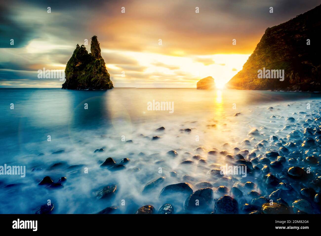 Scenic View Of Rocks In Sea Against Sky During Sunset Stock Photo