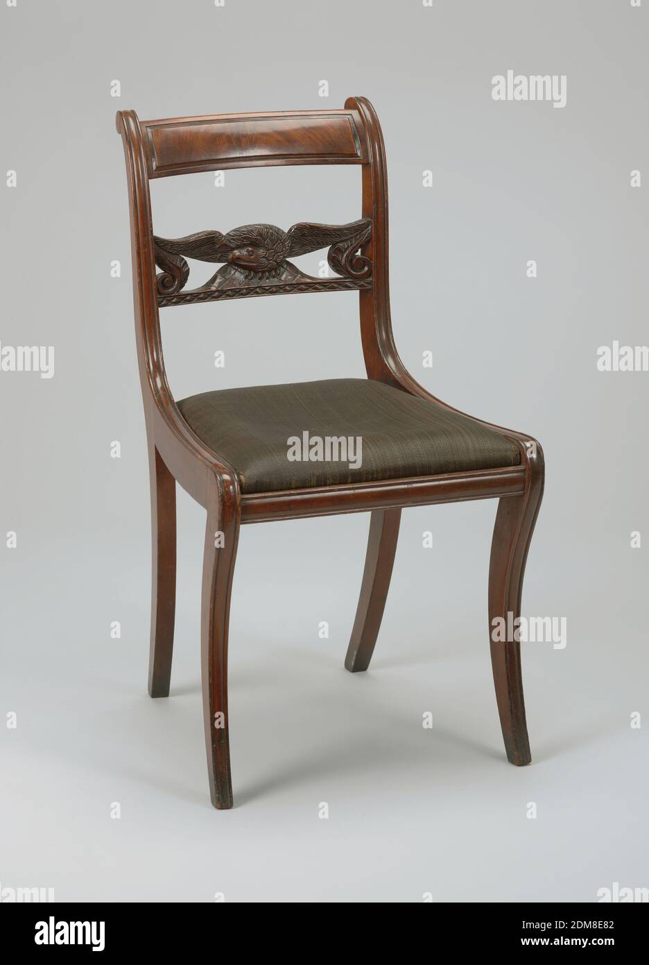 Chair, carved mahogany, Crozier posts include panelled top rail and slat carved in form of an eagle with wings outspread. Slip seat covered in horsehair. Flat front legs are moulded on front surface and are sharply curved. Rear legs are sharply curved as well., USA, 1820–25, furniture, Decorative Arts, Chair Stock Photo