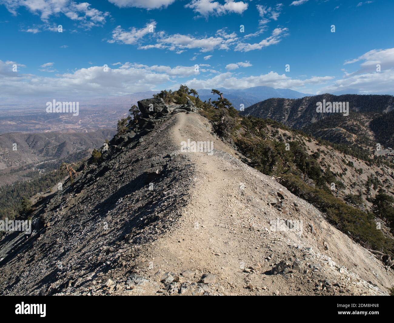 Devils backbone trail with partly cloudy sky on Mt. Baldy near Los