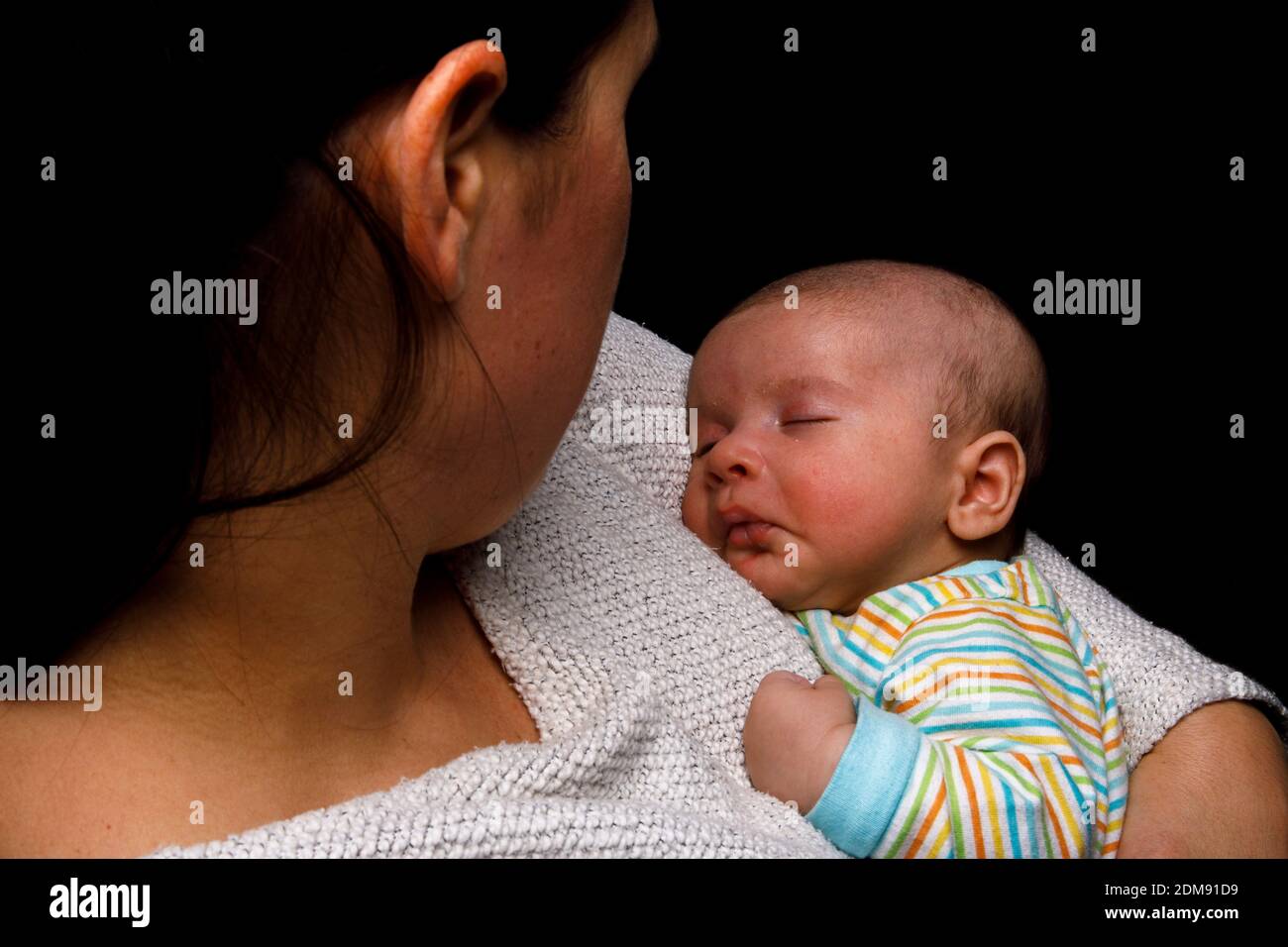 Cute baby sleeping in arms of mother Stock Photo Alamy