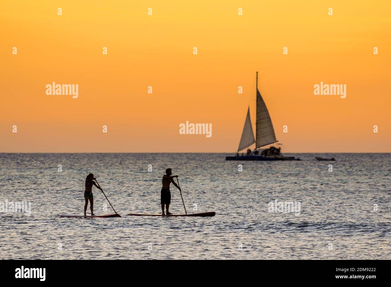 A couple enjoying water sports during sunset at Hadicurari Brach Stock Photo