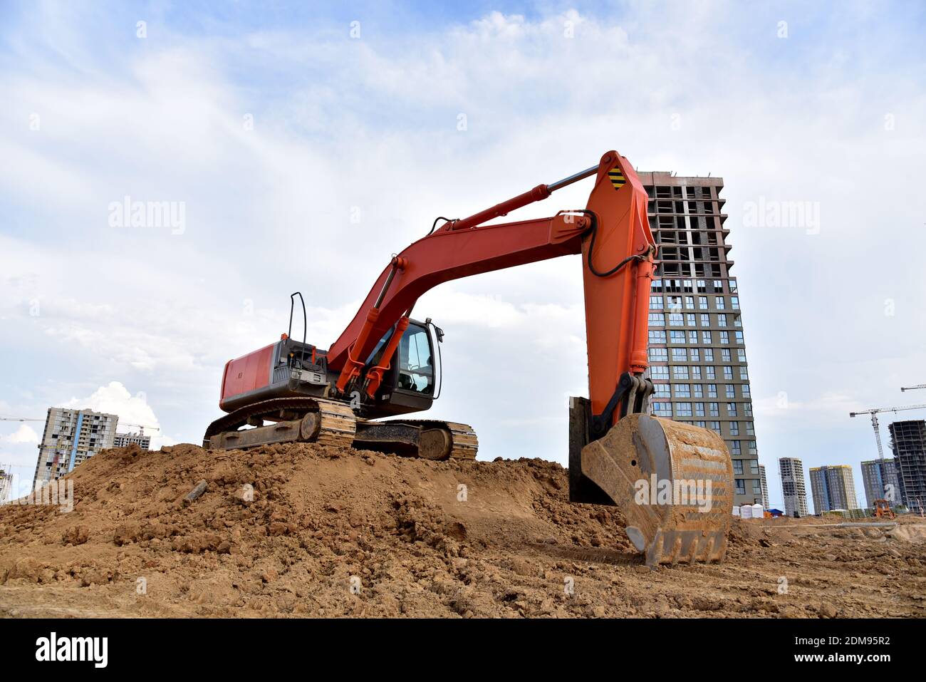 Digging the pit foundation a hole with excavator. Earthwork in