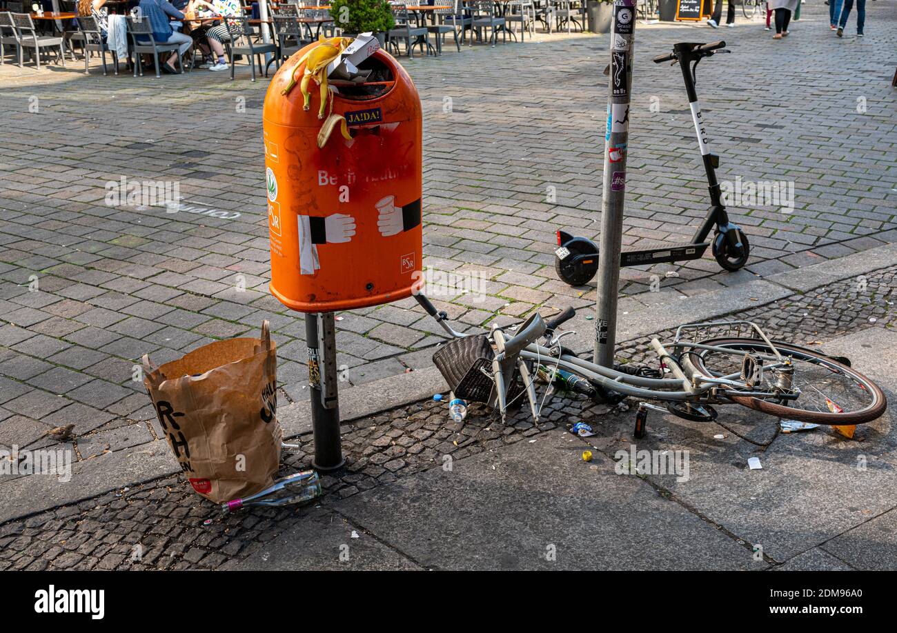 Trash And Dirt Next To A Public Trash Can In Berlin Stock Photo