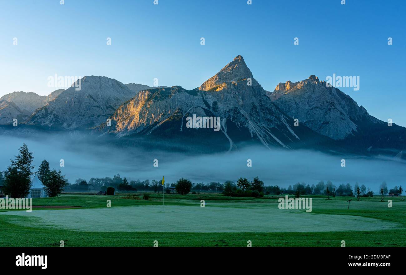 Golf Course On The Wetterstein Mountains In The Morning Mist Stock Photo