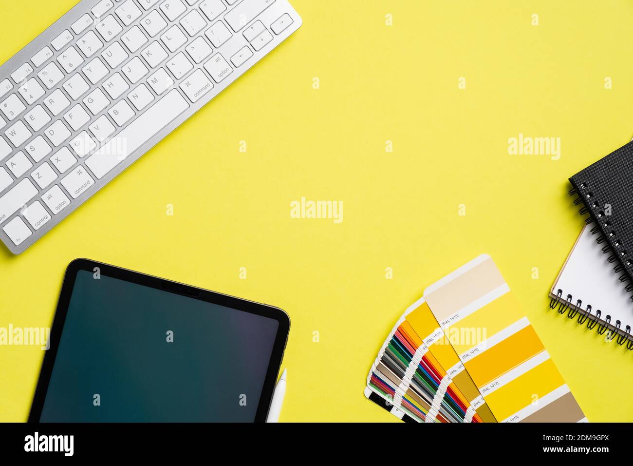Graphic designer office desktop with tablet, color guide palette ...
