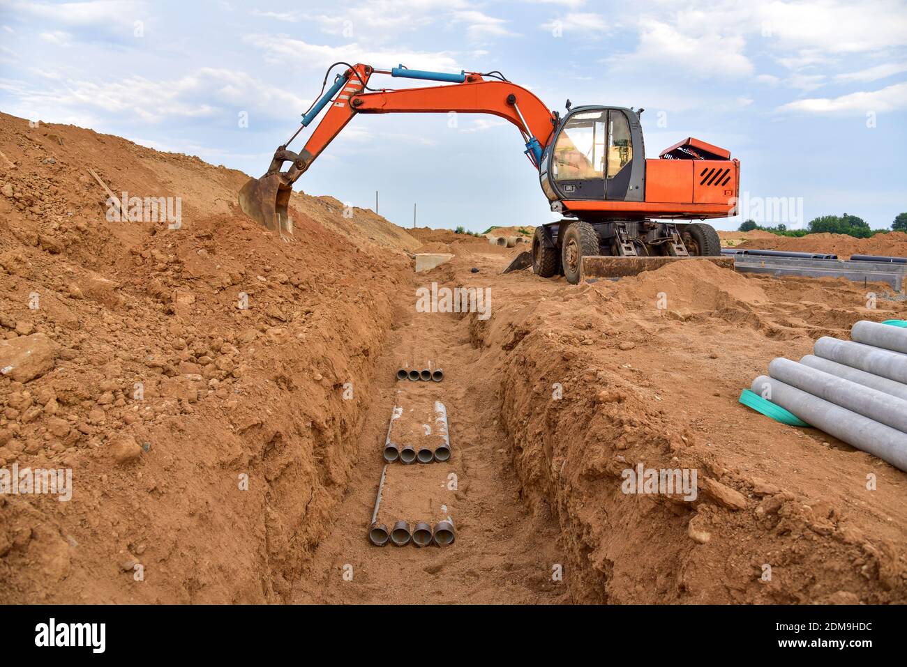Excavator dig the trenches at a construction site. Trench for laying ...