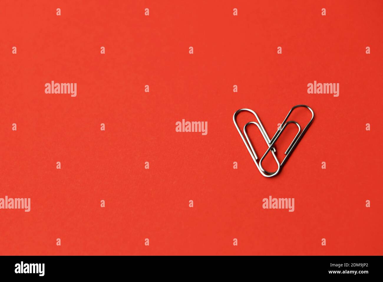 Heart shape paper clips on a red background. Valentine's day concept. High quality photo Stock Photo