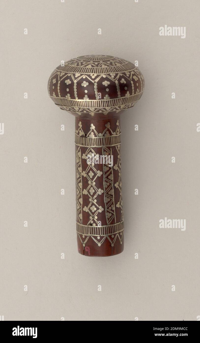Cane handle, Wood, inlaid silver, Small round knob, slightly flattened, set on short stem; wood inlaid in silver in completely conventionalized design; formed of small lines, dots in circular pattern or perpendicular pattern on stem., India, possibly Morocco, 19th century, metalwork, Decorative Arts, Cane handle Stock Photo