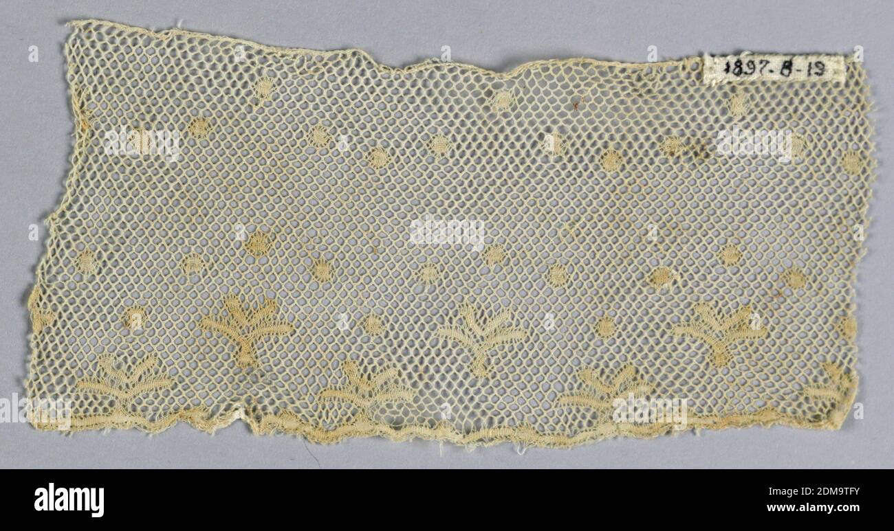 Fragment, Medium: linen Technique: bobbin lace, Fragment of Valenciennes lace has dots and conventionalized leaves in groups of four. Round mesh., France, 18th century, lace, Fragment Stock Photo