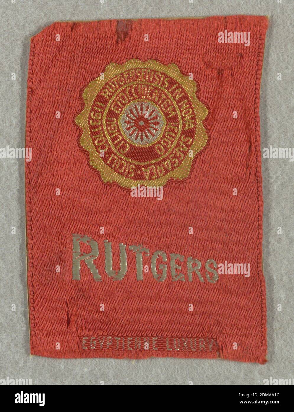 Souvenir, Medium: silk Technique: satin weave with supplementary weft, Red tobacco silk from Egyptienne Luxury cigarettes with seal of Rutgers University in yellow and white. Just below is 'Rutgers' in white sloping capital letters., USA, ca. 1910, woven textiles, Souvenir Stock Photo