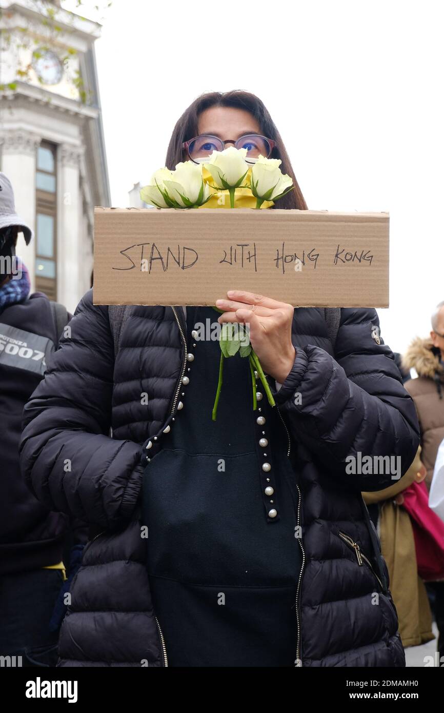 Hong Kong pro-democracy activists in London take part in a mourning event to highlight the erosion of human rights in the former British colony. Stock Photo