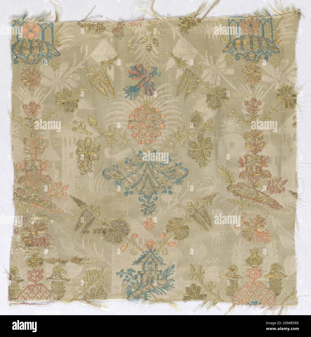 Fragment, Medium: silk, metal thread Technique: damassé foundation (8 harness satin plus plain weave). Satin patterned by floats of discontinuous supplementary wefts, Fragment of a pattern of two alternating verticals: architectural motifs, ornamental garden-like buildings, and flowers. Two lances from the top of a building in each row create a loose diamond lattic. Two level patterns; gold and muted colors on an ivory damassé background., France, late 17th century, woven textiles, Fragment Stock Photo
