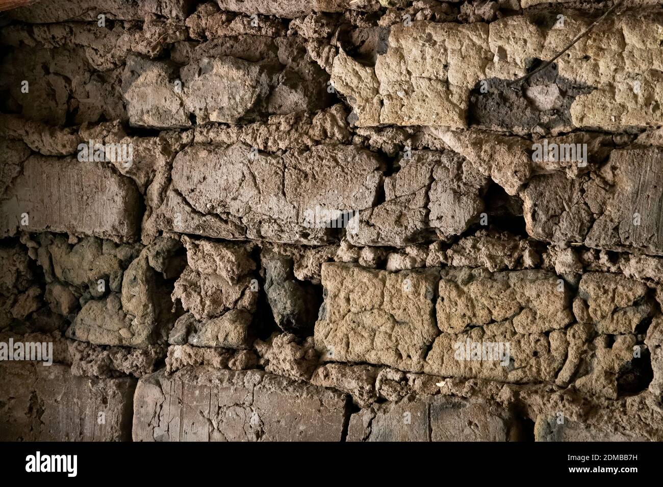 Detail of old adobe wall made of mud and clay bricks. Stock Photo