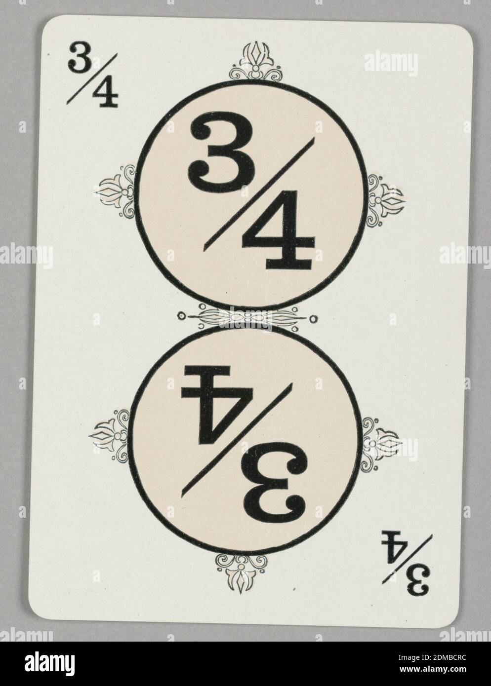 3/4 Fraction, Educational Game, The Cincinnati Game Company, Cincinnati, Ohio, USA, Lithograph on paper, Rectangular format playing card with rounded edges, for use in an educational game on fractions. A symmetrical design, the fraction 3/4 in a pale pink circle at upper center surrounded by decorative motifs at top, bottom, left, and right; the number 3/4 printed in black at upper left. The lower portion of the card is a translated repeat of the design., Europe and USA, 1902–05, toys & games, Playing card, Playing card Stock Photo