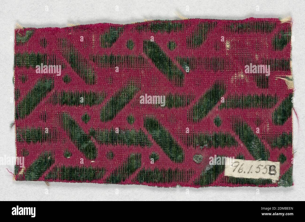 Fragments, Medium: silk Technique: supplementary warp forming raised pile in satin foundation (velvet), Vertical and diagonal bars and dots in green on a red background., 17th century, woven textiles, Fragments Stock Photo