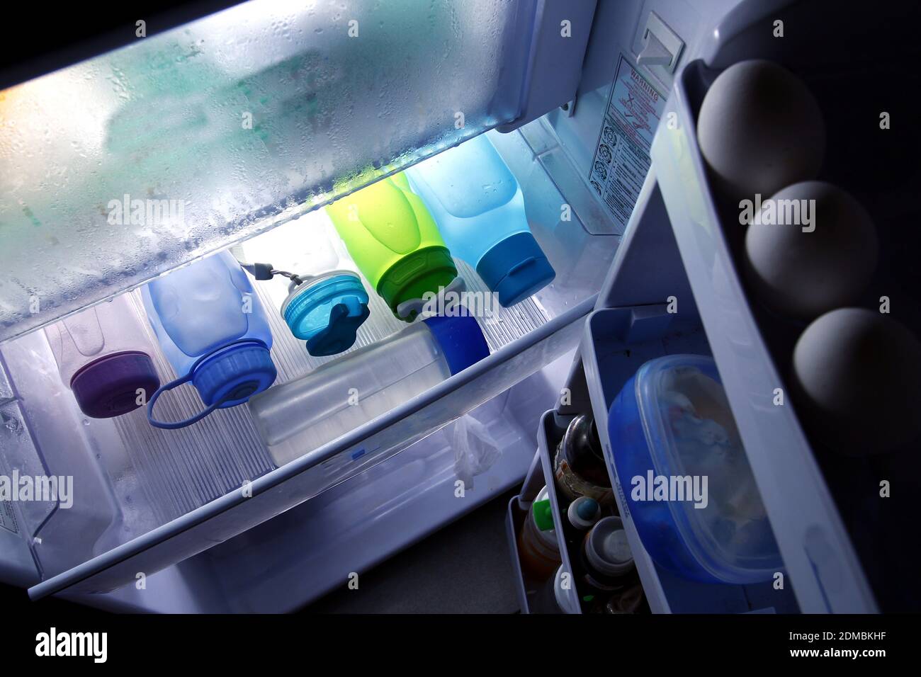 Photo of plastic drink tumblers filled with cold water in the chiller