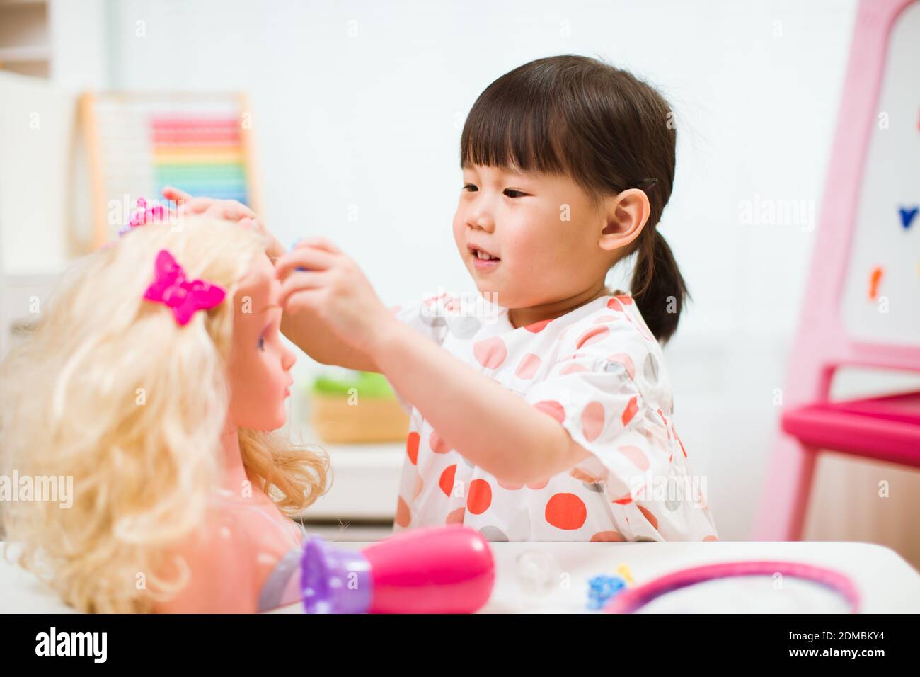toddler girl pretend play as hairdresser at home Stock Photo Alamy
