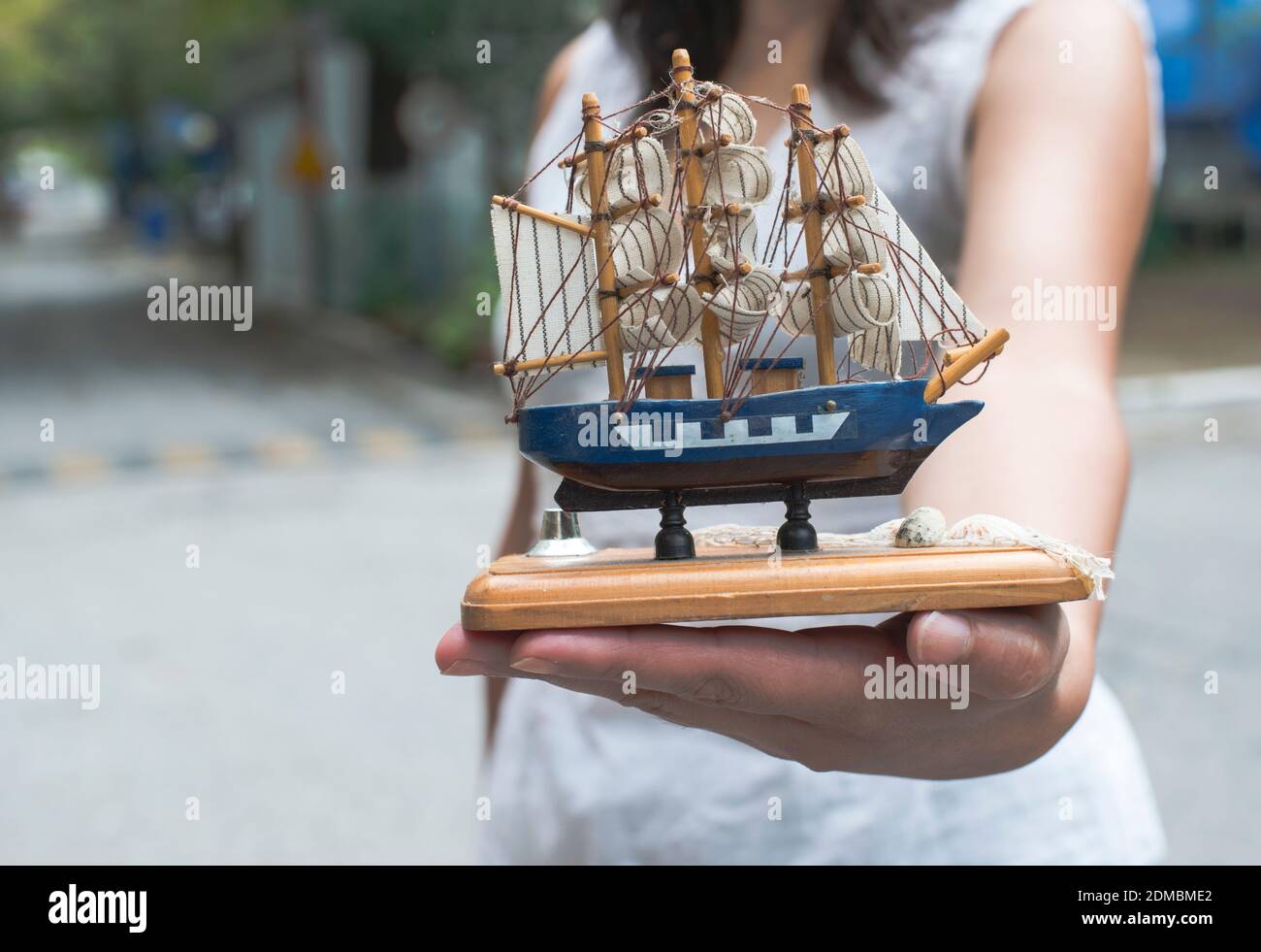 Hand holding model of a sailing ship Stock Photo - Alamy