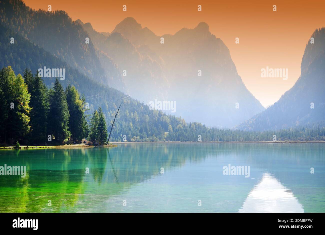 Panoramic View Of Lake And Mountains Against Sky During Sunset Stock Photo