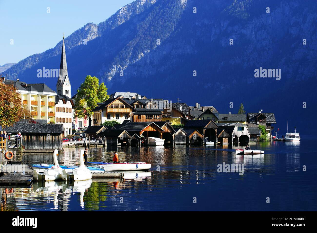 Houses By Lake And Buildings Against Sky Stock Photo
