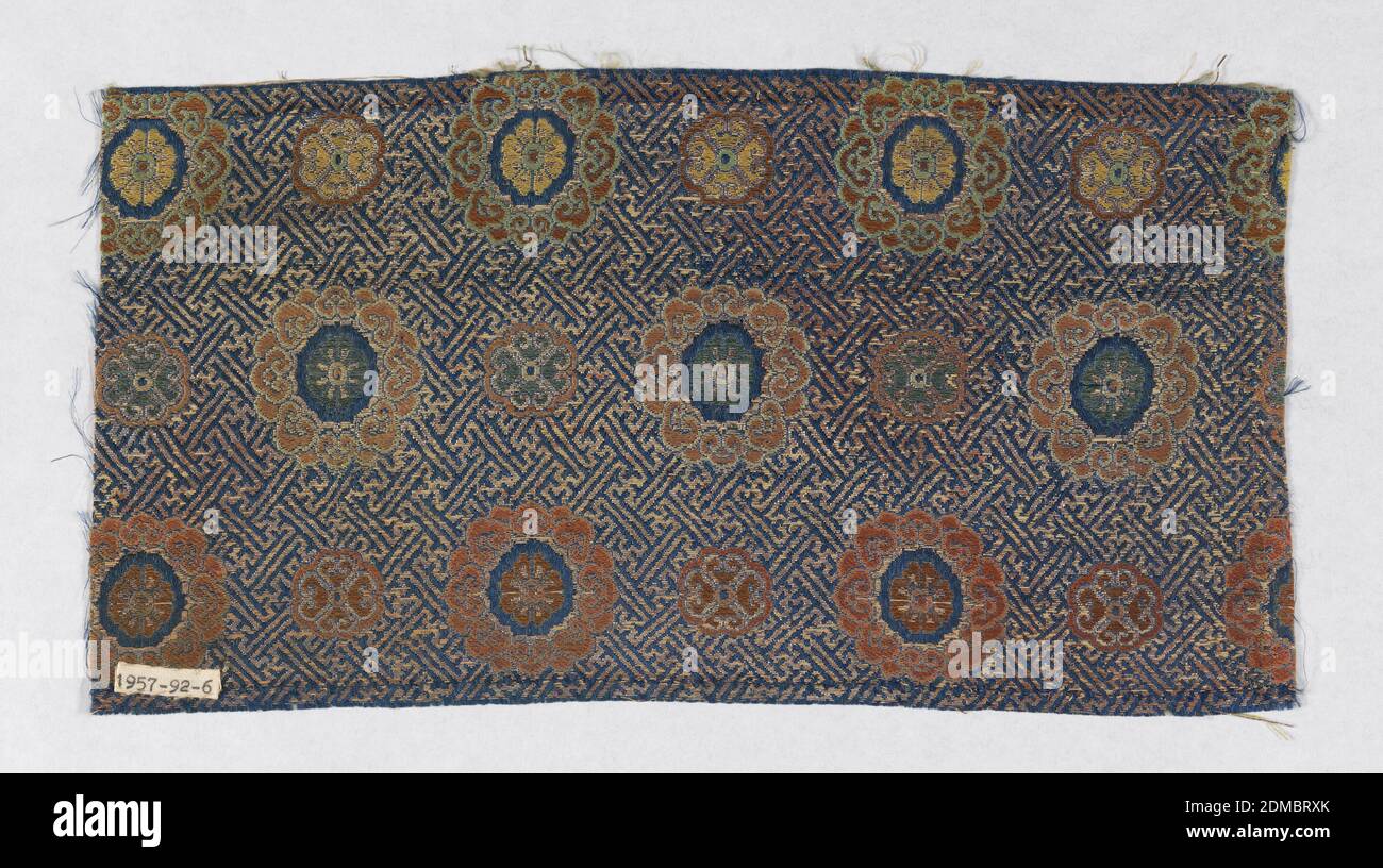Textile, Medium: silk, paper with applied gold foil Technique: plain compound weave, Blue ground with metallic gold continuous geometric pattern with swastikas. Horizontal pattern with alternating large and small flowers in multicolored threads., China, 19th century, woven textiles, Textile Stock Photo