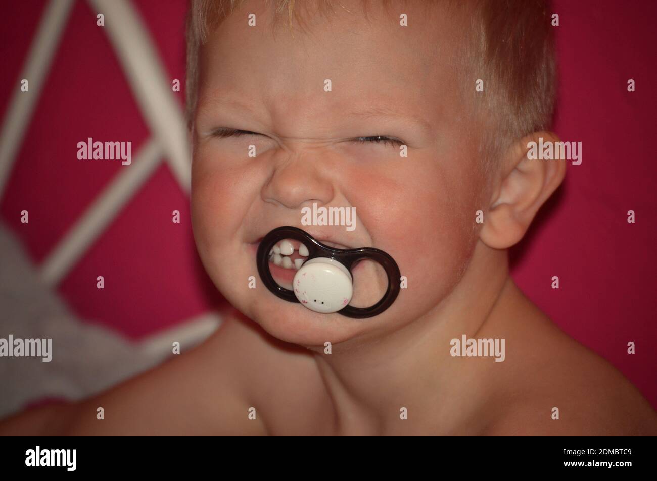Close-up Portrait Of Boy With Pacifier In Mouth Stock Photo