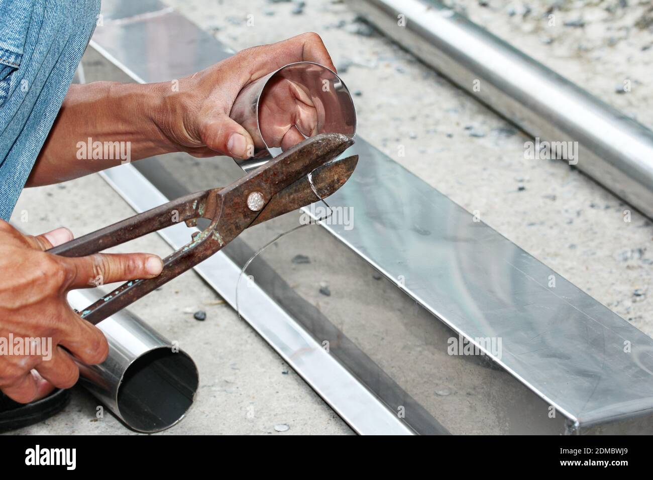 Aluminium gutter welding by using soldering copper with picnic gasTechnician cut aluminium pipe