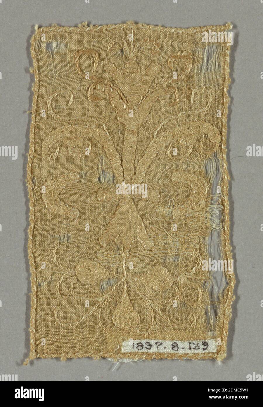 Fragment, Medium: linen Technique: applique and embroidery, Light brown rectangular fragment in a conventionalized design of scrolling leaves and floral forms., Belgium or France, early 17th century, embroidery & stitching, Fragment Stock Photo