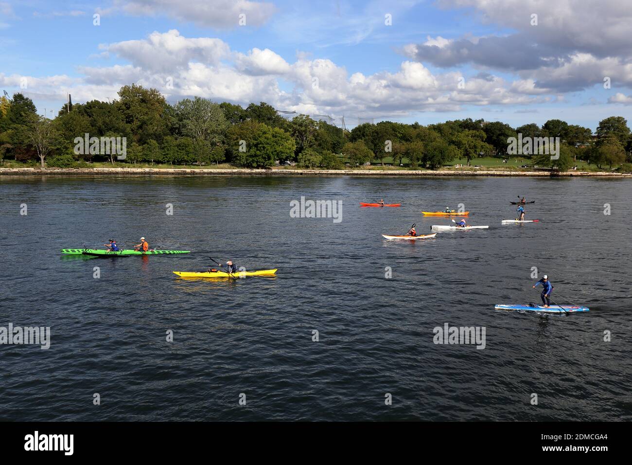 Kayakers, paddlers, canoers on the Harlem River between Manhattan and Randalls Island in New York, NY. Stock Photo