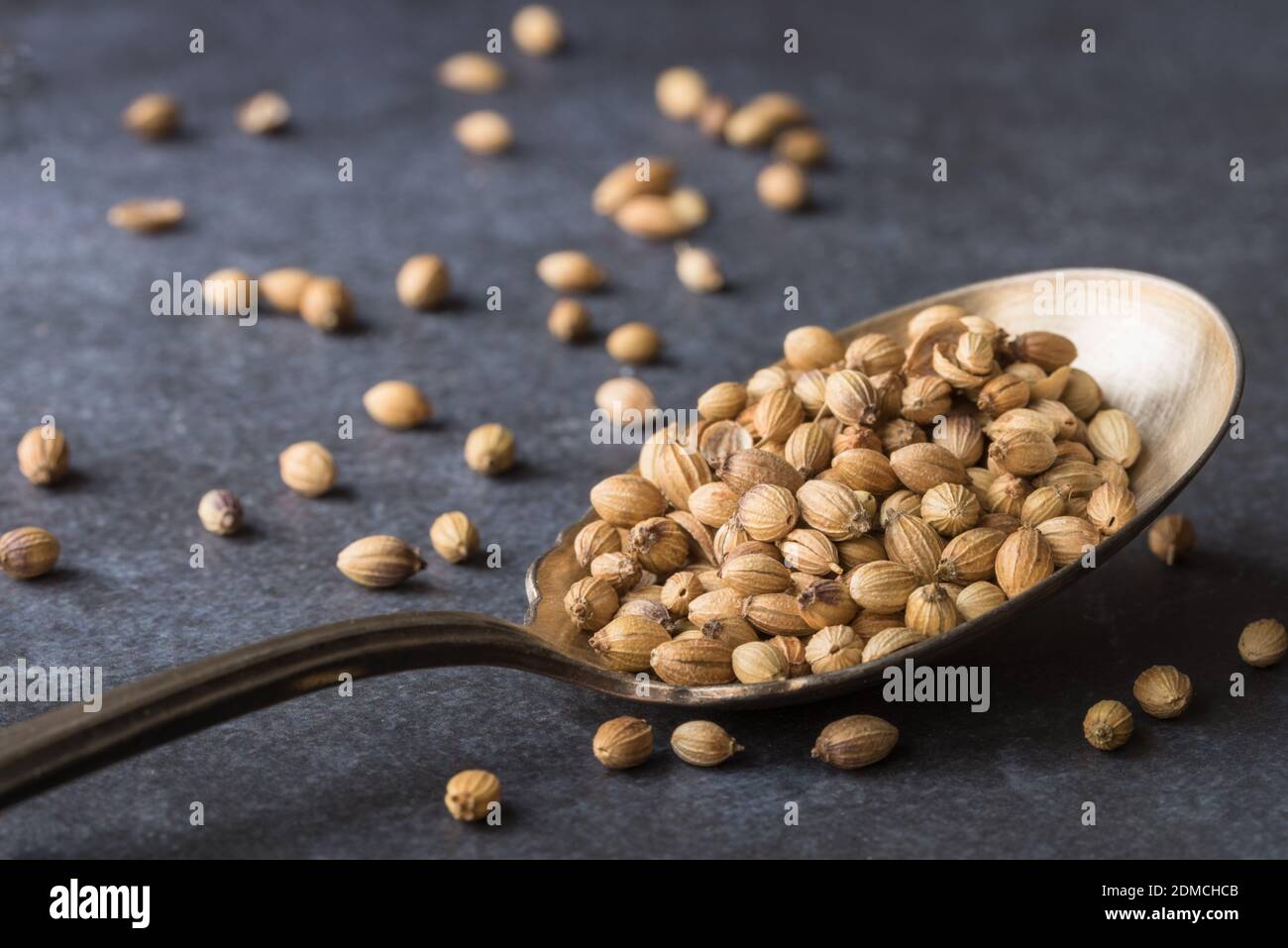 Close-up Of Coriander Seeds In Spoon On Table Stock Photo