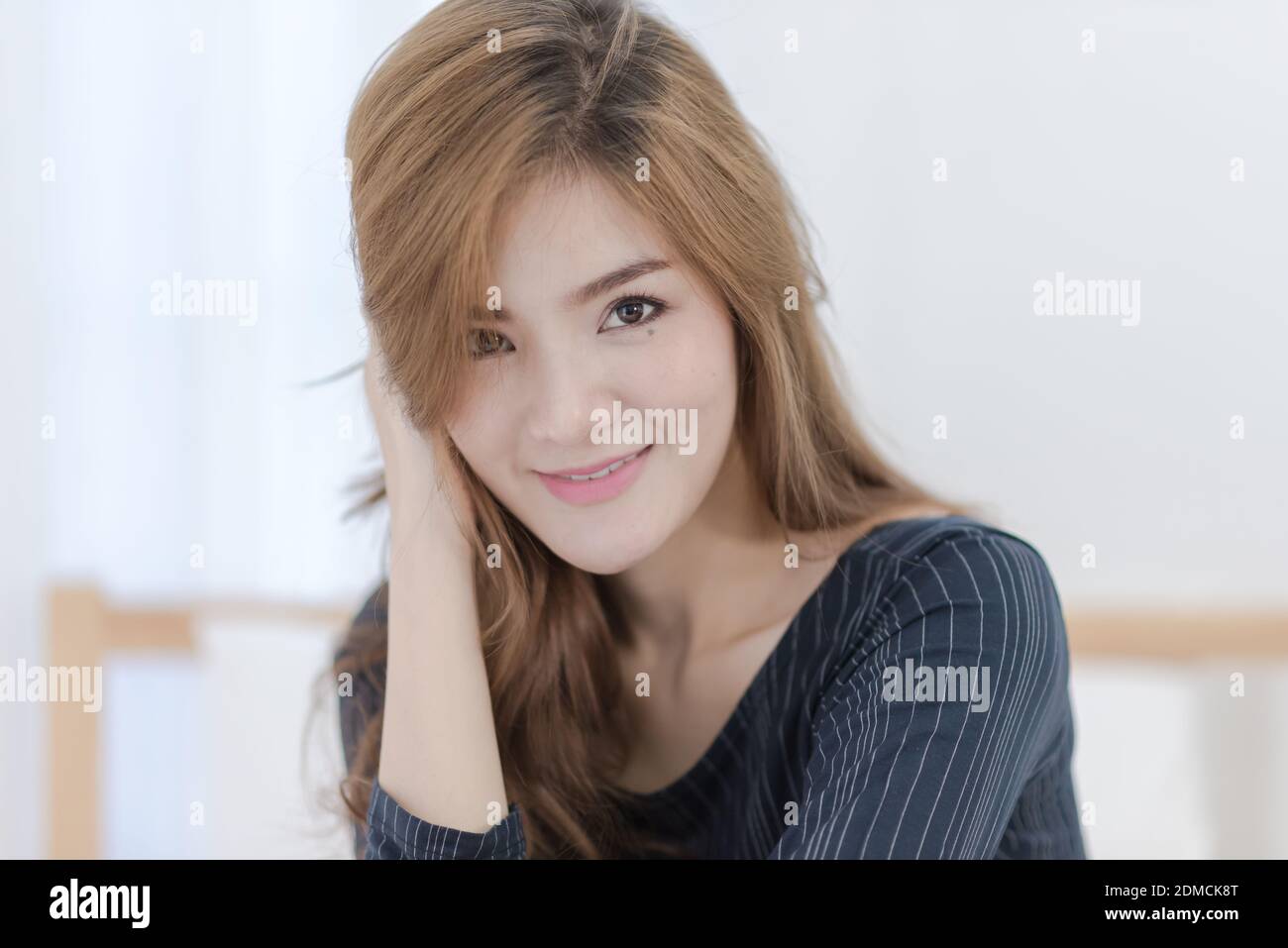 Close-up Portrait Of Smiling Young Woman At Home Stock Photo