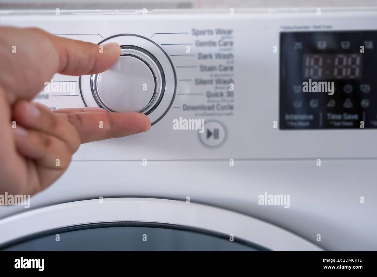 washing machine Choosing Program On Washing Machine Stock Photo Alamy