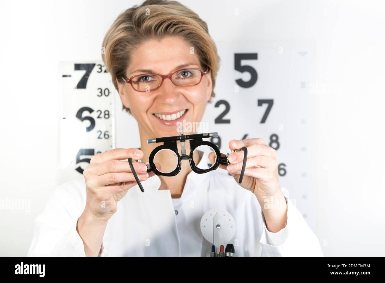 Young eye doctor W34 with testing frame on the eye chart, Germany, Europe Stock Photo