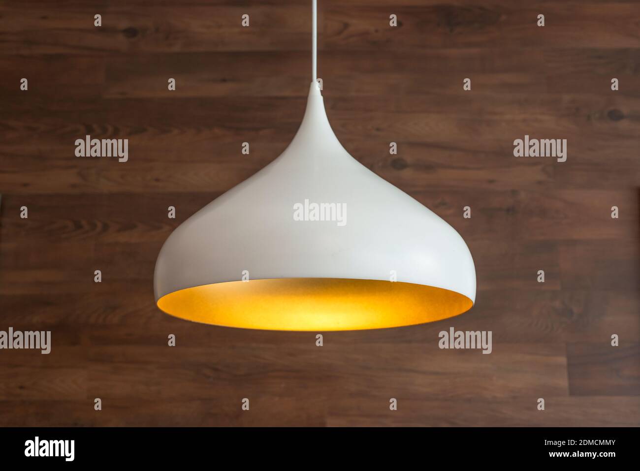 Close-up Of Pendant Light Hanging Against Wooden Wall Stock Photo