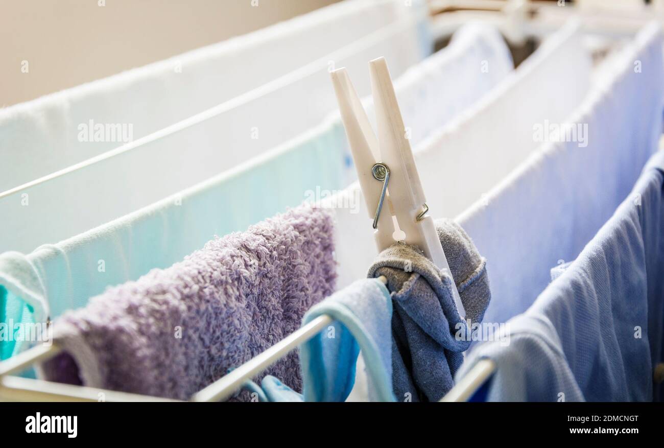 different types of clothes left hanging to dry kept by a clothespin on