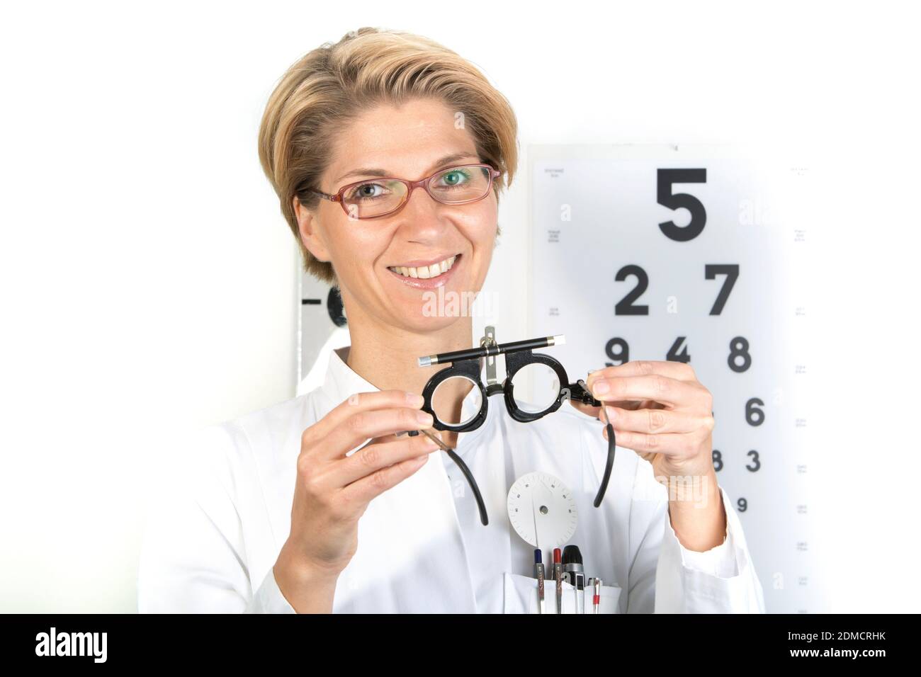 Young eye doctor W34 with testing frame on the eye chart, Germany, Europe Stock Photo