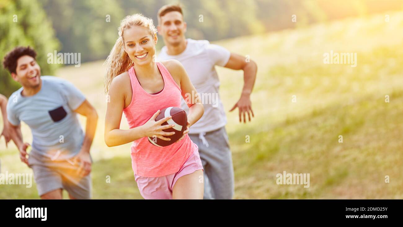 Group of friends playing rugby and having fun as a team in summer Stock ...