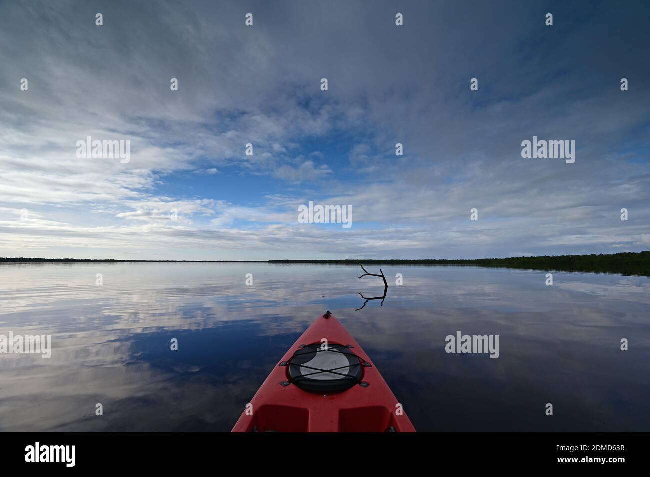 Red kayak on Coot Bay in Everglades National Park, Florida under winter cloudscape reflected in tranquil water, Stock Photo