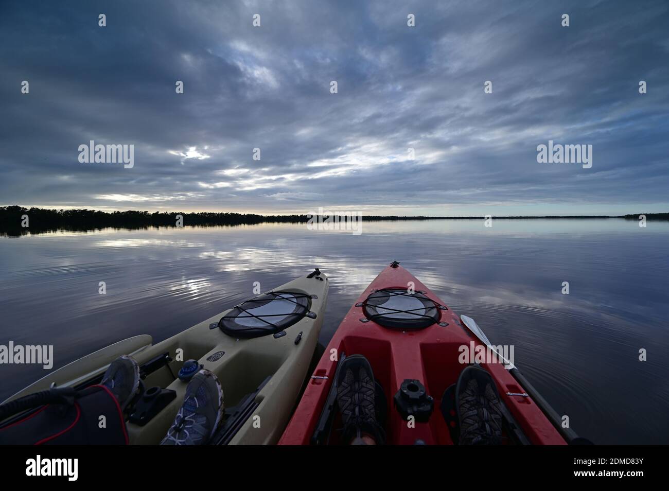 Everglades National Park, Florida - December 12, 2020 - Two kayaks at sunset on Coot Bay under dramatic winter cloudscape reflected in tranquil water. Stock Photo