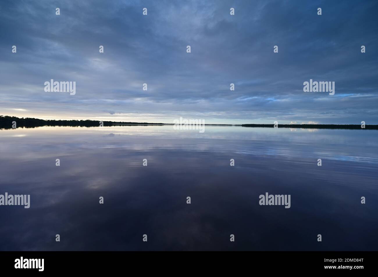 Winter cloudscape reflected in tranquil water of Coot Bay in Everglades National Park in late afternoon. Stock Photo