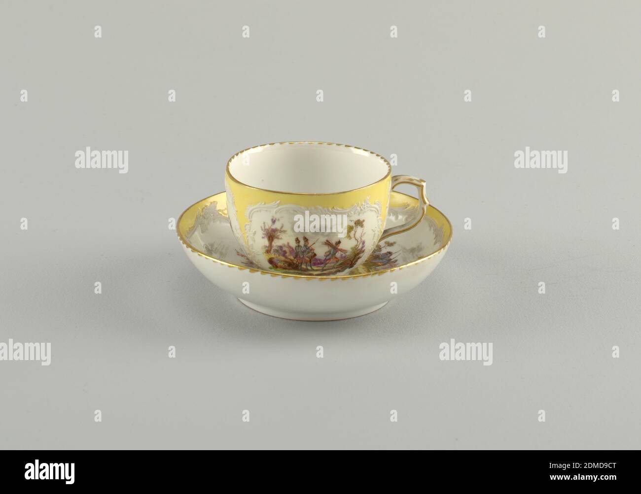 Cup and Saucer with Battle Scenes (Bataillen-Malerei), Royal Porcelain Manufactory, Berlin, German, established 1763, hard paste porcelain, vitreous enamel, gold, Curving cup. Slightly compressed in lower part. Scrolling handle. Saucer slightly curved. Decoration identical to that of 1953-17-50., Germany, 1870–1900, ceramics, Decorative Arts, cup and saucer, cup and saucer Stock Photo