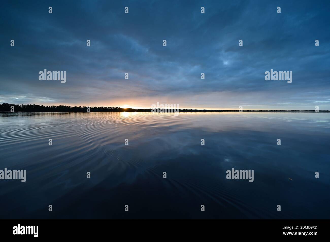 Winter cloudscape reflected in tranquil water of Coot Bay in Everglades National Park in late afternoon. Stock Photo