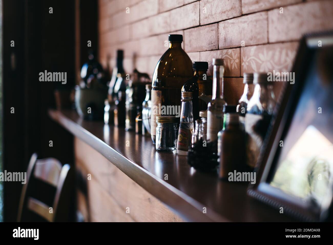 Chemical bottles on shelf vintage brick wall Stock Photo