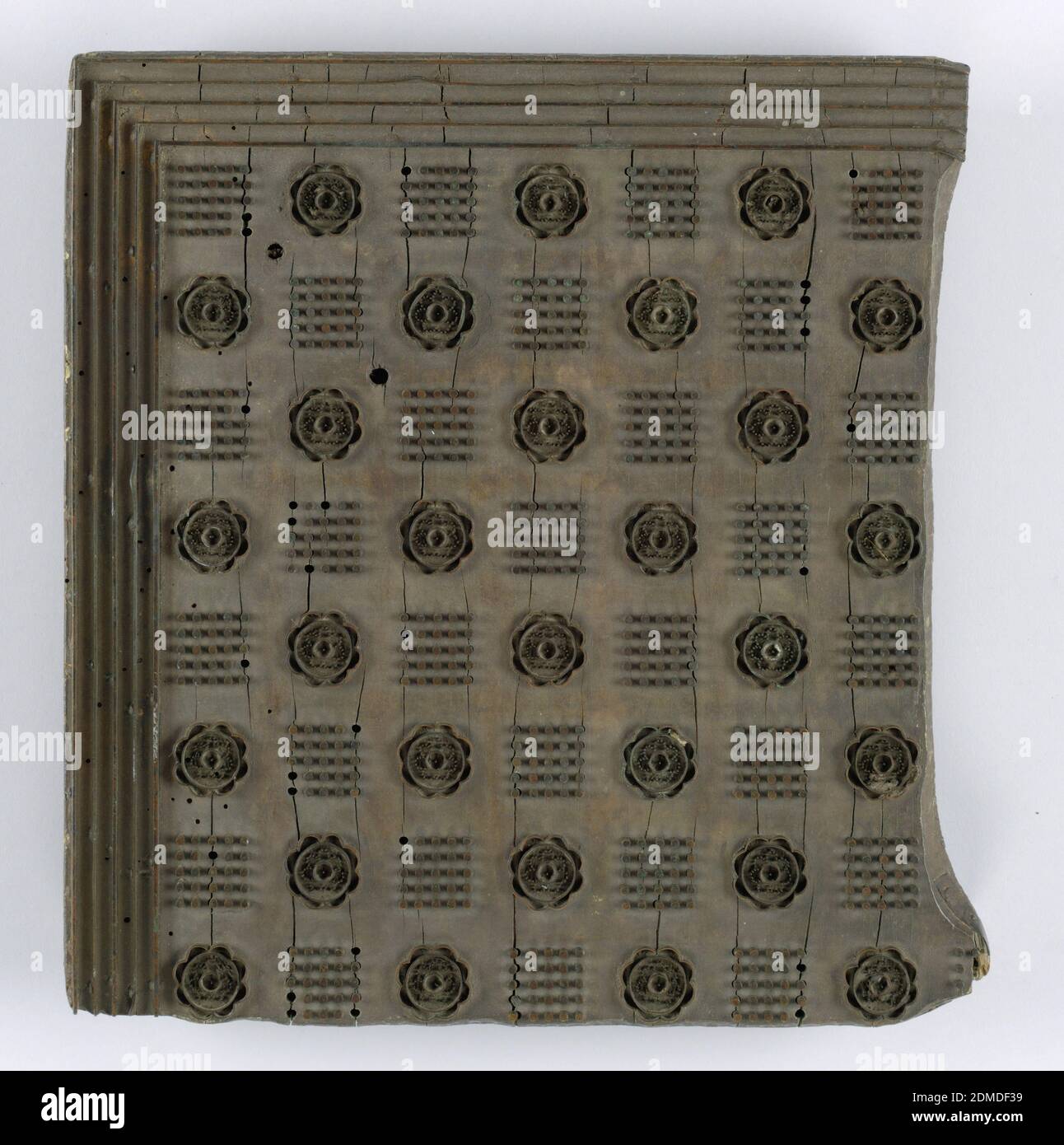 Printing block, Medium: wood, metal, Part of a design for a table cloth with squares formed by dots and a rose alternating. A border of five flat metal strips., USA, 19th century, appliances & tools, Printing block Stock Photo