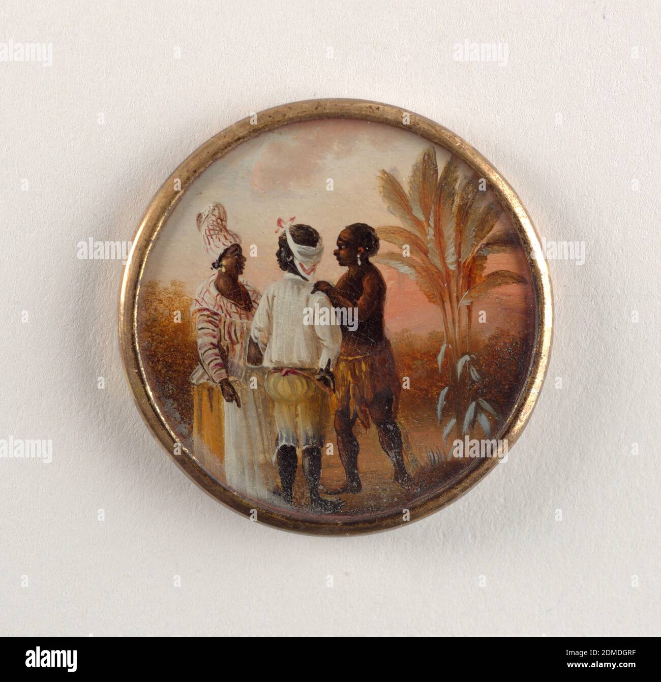 Button, Gouache paint on tin verre fixé, ivory (backing), glass, gilt metal, Button depicting scene of three conversing figures in a landscape with palm trees. A woman dressed in a striped shirt and turban, a man facing the woman with back to viewer in striped pants and white shirt, and a second man wearing native West Indies dress in skirt and headband., late 18th century, costume & accessories, Decorative Arts, Button Stock Photo