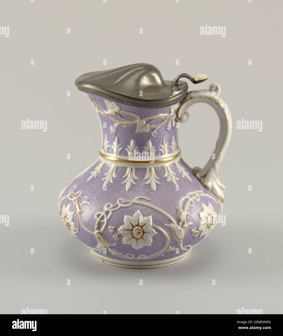 Covered pitcher, Wedgwood, English, established 1759, Molded, glazed and gilt stoneware, white metal (mount), Body of squat pear shape, on circular molded base. Molded band between body and flare neck. Applied scrolled handle. Body with 'orange skin' texture overall, glazed in mauve. Raised decoration in white of floral rosettes and tendril vines; decoration highlighted with gilding. Jug fitted with hinged metal cover in the form of a domed shell. Thumbpiece above scroll handle fitted with ceramic button., ca. 1861, ceramics, Decorative Arts, Covered pitcher Stock Photo