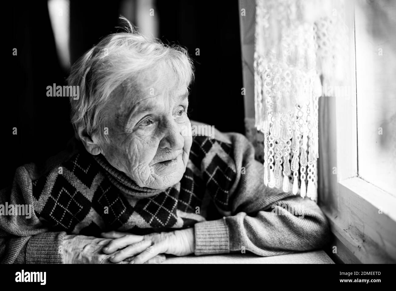 An old woman portrait sitting at her home. Black and white photo Stock ...
