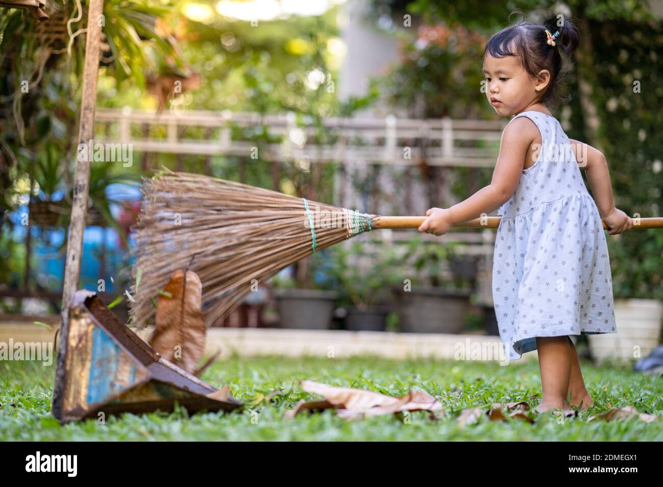 Full Length Of Girl Holding Broom On Grass Stock Photo Alamy