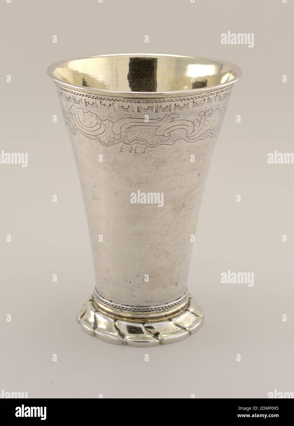 Beaker, silver, gold, Tall flaring body with punched lambrequin motif above engraved shell and scroll band and initials E.H.S. Wavy relief band at top and bottom. Flaring gadrooned foot, with traces of gilding. Interior gilded., Stockholm, Sweden, 1760, metalwork, Decorative Arts, beaker, beaker Stock Photo
