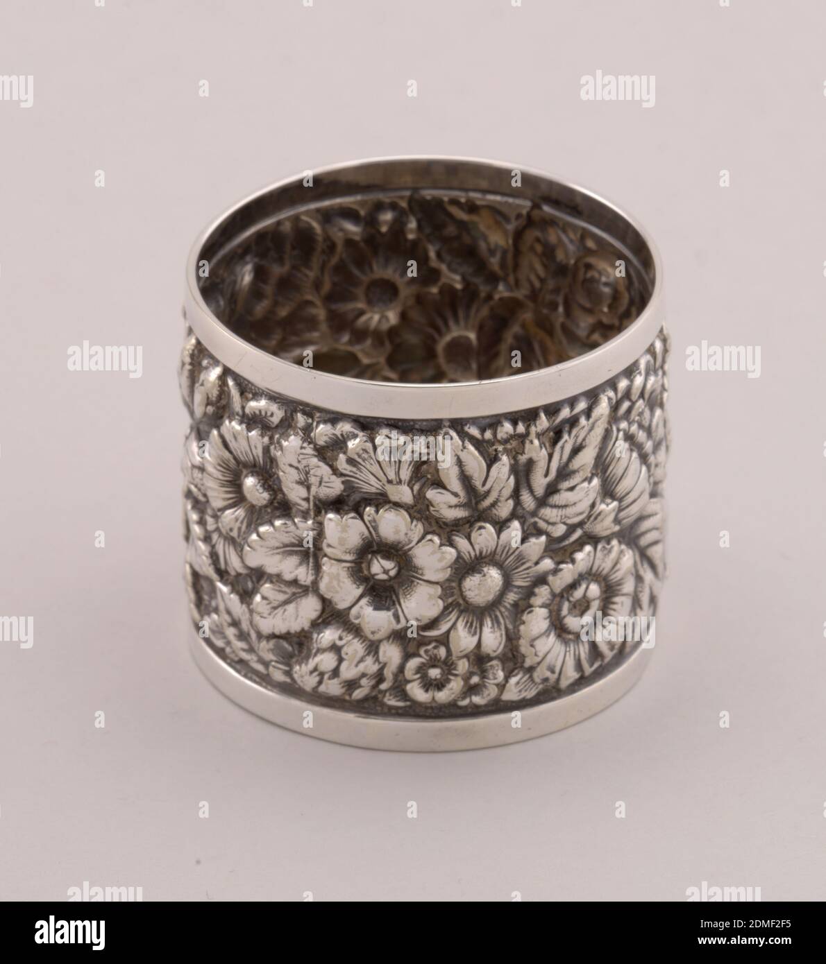 Toothpick holder, Tiffany & Company, American, established 1853, Electroplated silver and nickle, Small cylindrical cup with straight sides repoussé and chased all over with flowers between plain bands at foot and rim., New York, New York, USA, late 19th century, metalwork, Decorative Arts, Toothpick holder Stock Photo